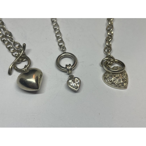 545 - THREE SILVER T BAR BRACELETS WITH HEART CHARMS