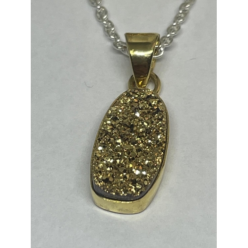 560 - A SILVER NECKLACE WITH SILVER GILT PENDANT AND MATCHING RING IN A PRESENTATION BOX