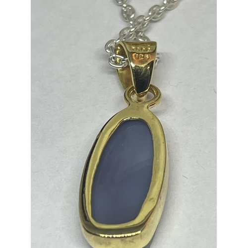 560 - A SILVER NECKLACE WITH SILVER GILT PENDANT AND MATCHING RING IN A PRESENTATION BOX