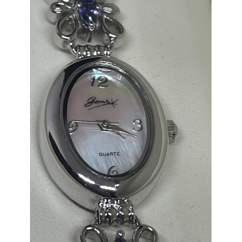 562 - A DECORATIVE STERLING SILVER LADIES GEMS WRIST WATCH WITH PURPLE STONES IN A PRESENTATION BOX WITH C... 