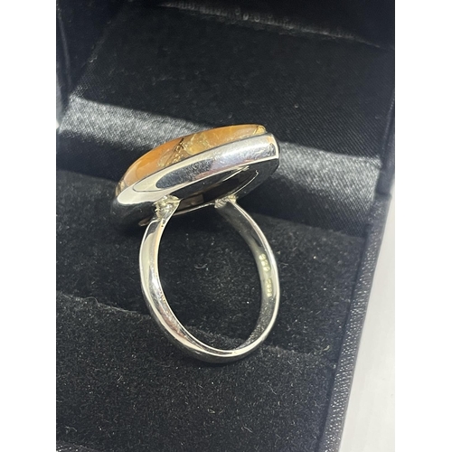 563 - A SILVER RING WITH LARGE AMBER COLOURED STONE IN A PRESENTATION BOX