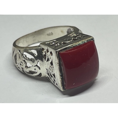 566 - A DECORATIVE SILVER RING WITH A SQUARE RED STONE IN A PRESENTATION BOX