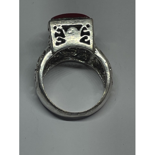 566 - A DECORATIVE SILVER RING WITH A SQUARE RED STONE IN A PRESENTATION BOX