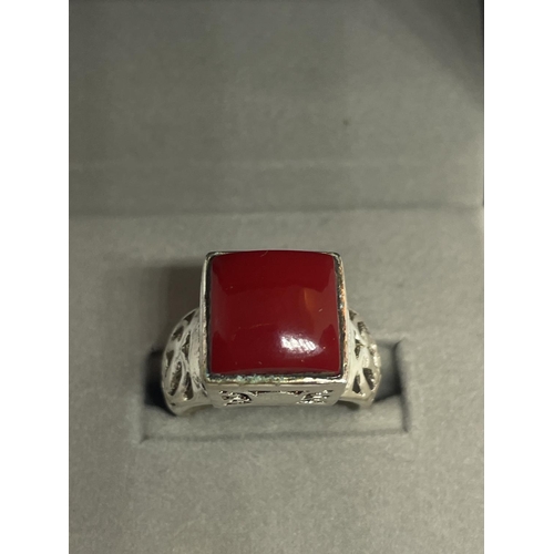 566 - A DECORATIVE SILVER RING WITH A SQUARE RED STONE IN A PRESENTATION BOX