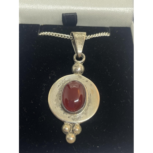 572 - A SILVER NECKLACE WITH A RED STONE PENDANT IN A PRESENTATION BOX