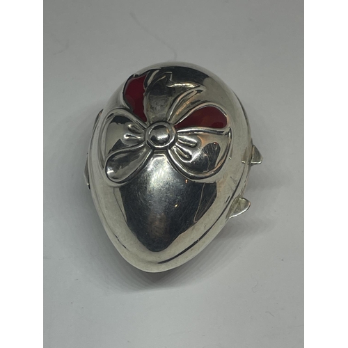 577 - A SILVER EGG SHAPED PILL BOX WITH RIBBON DESIGN ON THE LID