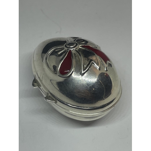 577 - A SILVER EGG SHAPED PILL BOX WITH RIBBON DESIGN ON THE LID