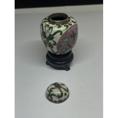 581 - AN ENAMELLED MINIATURE GINGER JAR ON A WOODEN PLINTH