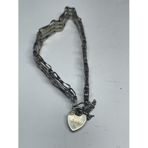 606 - TWO SILVER FOUR BAR GATE BRACELETS WITH HEART PADLOCK FASTENERS