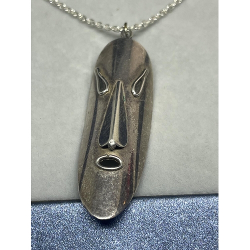 613 - A SILVER NECKLACE WITH A MASK PENDANT IN A PRESENTATION BOX