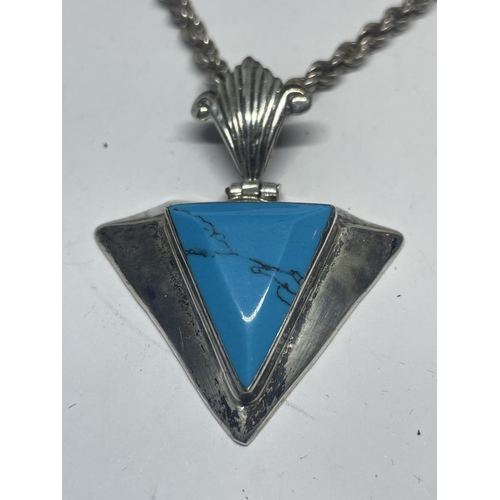 615 - A SILVER ROPE NECKLACE WITH ART DECO STYLE TRIANGULAR TURQUOISE STONE PENDANT IN A PRESENTATION BOX