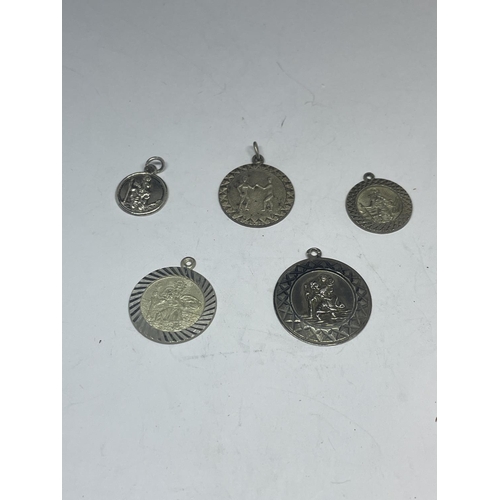 625 - FIVE SILVER ST CHRISTOPHER PENDANTS