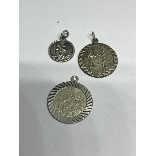 625 - FIVE SILVER ST CHRISTOPHER PENDANTS