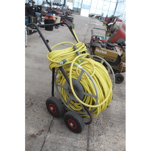 29 - A LARGE MARKET GARDENERS HOSE AND FOUR WHEELED TROLLEY REEL NO VAT