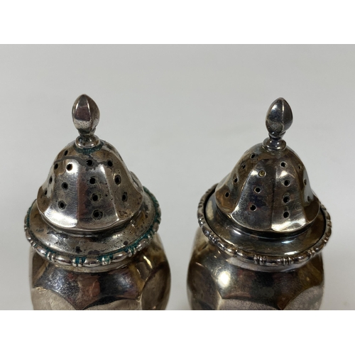 21 - A PAIR OF BIRMINGHAM HALLMARKED SILVER SALT AND PEPPER SHAKERS, HEIGHT 10.5CM, TOTAL WEIGHT 84G