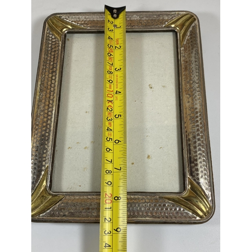 31 - A VINTAGE HAMMERED WHITE METAL PHOTO FRAME, POSSIBLY SILVER BUT UNMARKED, 22 X 17CM