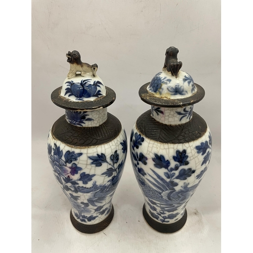 41 - A PAIR OF LATE 19TH CENTURY CHINESE CRACKLE GLAZE BLUE AND WHITE LIDDED TEMPLE VASES, SEAL MARKS TO ... 