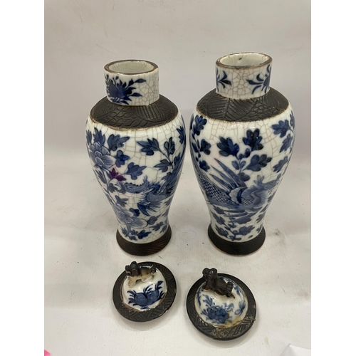 41 - A PAIR OF LATE 19TH CENTURY CHINESE CRACKLE GLAZE BLUE AND WHITE LIDDED TEMPLE VASES, SEAL MARKS TO ... 