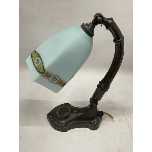 50 - AN ART NOUVEAU METAL TABLE LAMP WITH FROSTED GLASS SHADE