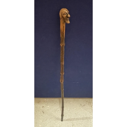 57 - A VINTAGE WOODEN WALKING STICK WITH FIGURE HEAD DESIGN TOP