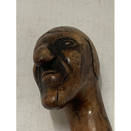 57 - A VINTAGE WOODEN WALKING STICK WITH FIGURE HEAD DESIGN TOP