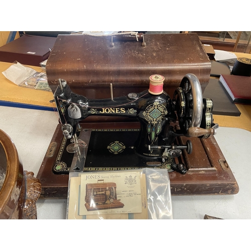 58 - A VINTAGE CASED JONES SEWING MACHINE WITH ORIGINAL BOOKLET