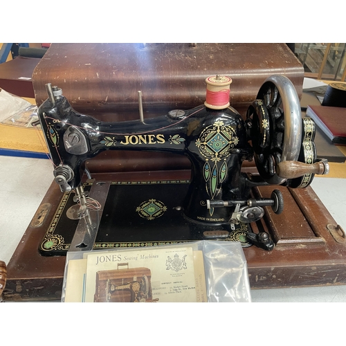 58 - A VINTAGE CASED JONES SEWING MACHINE WITH ORIGINAL BOOKLET