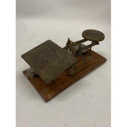 136 - A SET OF BRASS AND WOOD POST OFFICE SCALES WITH WEIGHTS