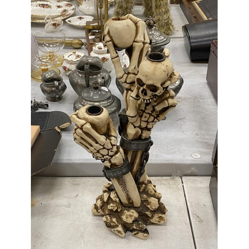 173 - A RESIN SKELETON CANDLESTICK HEIGHT 34CM, A SKELETON BRIDE AND GROOM AND TWO TANKARDS