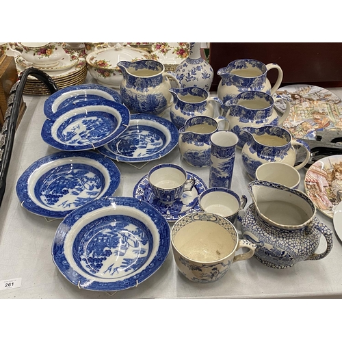 261 - A LARGE QUANTITY OF VINTAGE BLUE AND WHITE POTTERY TO INCLUDE JUGS, BOWLS, CUPS, ETC