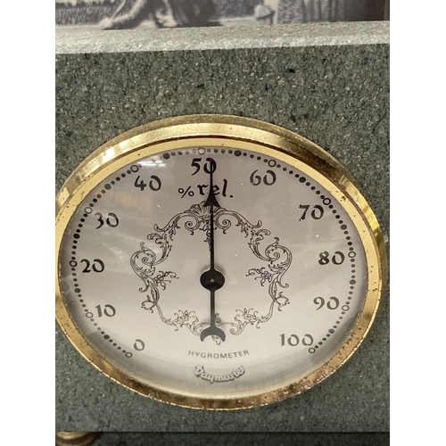 830 - A SLATE MANTLE CLOCK WITH A SHEPHERD AND SHEEPDOG IMAGE AND A SLATE BAROMETER AND HYGROMETER