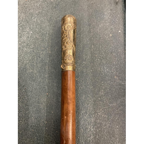 297 - A WOODEN SWAGGER STICK WITH A YELLOW METAL TOP