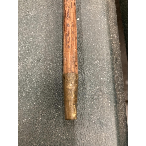 297 - A WOODEN SWAGGER STICK WITH A YELLOW METAL TOP