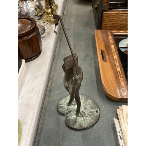 299 - A BRONZE STYLE FROG PLAYING GOLF ON A LILY PAD, HEIGHT 25CM