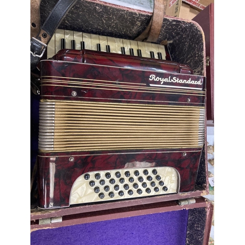 353 - A VINTAGE ROYAL STANDARD ACCORDIAN WITH RED BAKELITE BODY IN THE ORIGINAL CASE