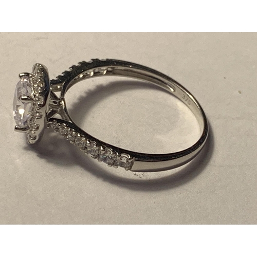 519 - A 9 CARAT WHITE GOLD RING WITH A LARGE SQUARE CUBIC ZIRCONIA ALSO SURROUNDED AND ON THE SHOULDERS SI... 