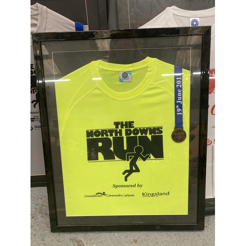 897 - THREE FRAMED AND GLAZED WINNERS SHIRTS AND MEDALS FROM THE NORTH DOWNS RUNS