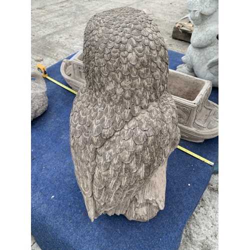 73 - A LARGE CONCRETE GARDEN ORNAMENTT IN THE FORM OF AN OWL ON A BRANCH NO VAT