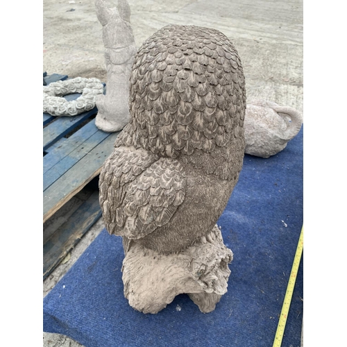 73 - A LARGE CONCRETE GARDEN ORNAMENTT IN THE FORM OF AN OWL ON A BRANCH NO VAT