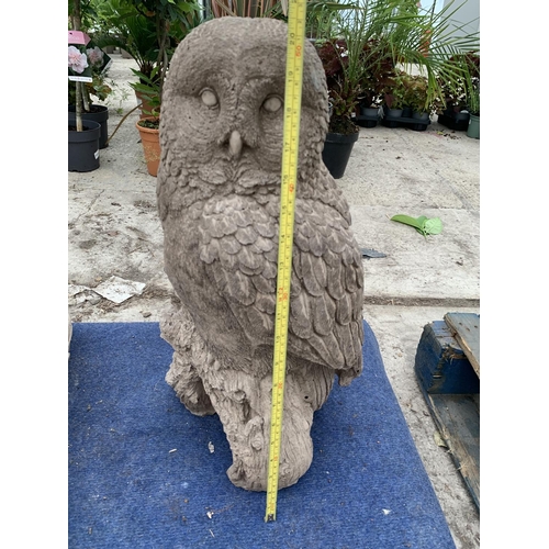 73 - A LARGE CONCRETE GARDEN ORNAMENTT IN THE FORM OF AN OWL ON A BRANCH NO VAT