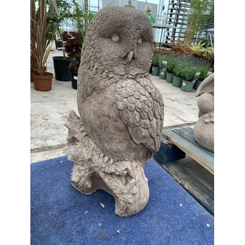 73 - A LARGE CONCRETE GARDEN ORNAMENTT IN THE FORM OF AN OWL ON A BRANCH NO VAT