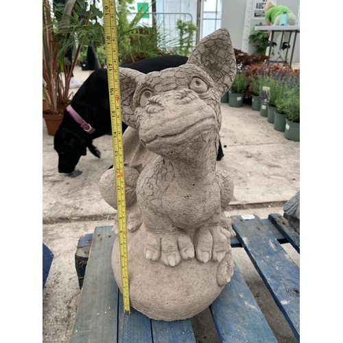 75 - A CONCRETE GARDEN ORNAMENT IN THE FORM OF A DRAGON SITTING ON AN EGG NO VAT