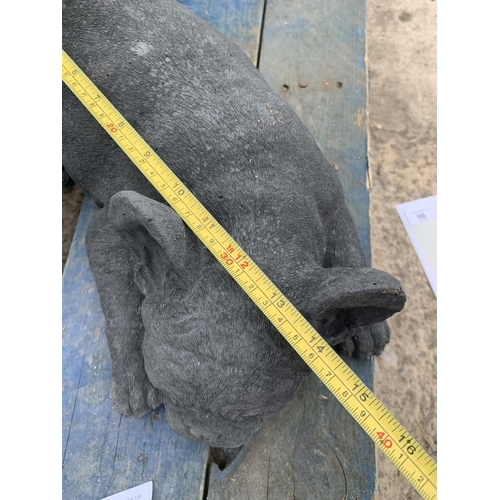 81 - A CONCRETE GARDEN ORNAMENT IN THE FORM OF A FRENCH BULLDOG LYING DOWN NO VAT