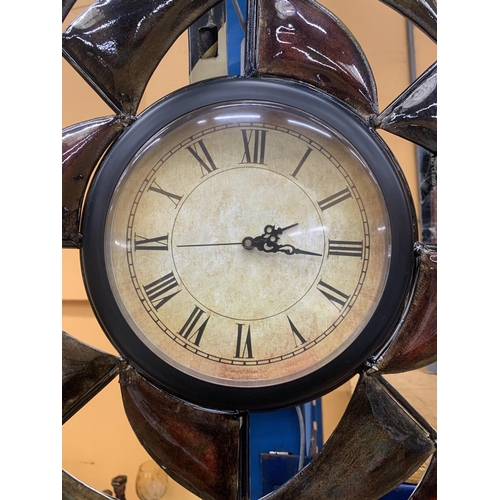 407 - A METAL WALL CLOCK WITH ENAMELLED DECORATION - WORKING AT TIME OF CATALOGUING - NO GUARANTEE GIVEN