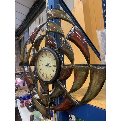 407 - A METAL WALL CLOCK WITH ENAMELLED DECORATION - WORKING AT TIME OF CATALOGUING - NO GUARANTEE GIVEN