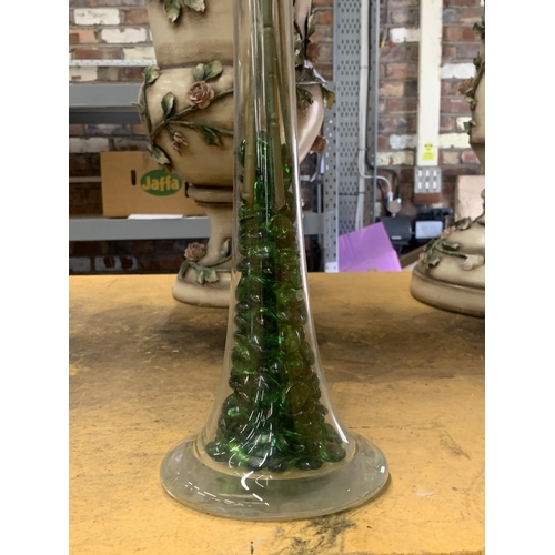 437 - A TALL GLASS VASE WITH AN ARTIFICAL FLOWER DISPLAY