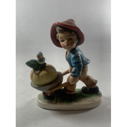 754 - THREE WESTERN GERMAN FIGURES TO INCLUDE A BOY WITH A WHEELBARROW, A TELEPHONE ETC