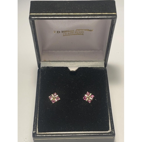 640 - A PAIR OF 9 CARAT GOLD EARRINGS WITH FOUR DEEP PINK STONES IN A SQUARE DESIGN PRESENTED IN A BOX