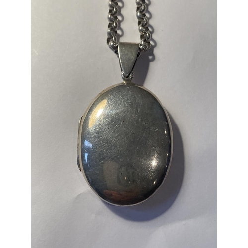 680 - A LARGE SILVER LOCKET ON A BELCHER CHAIN