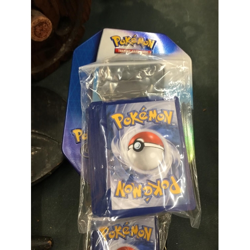 197 - TWO COLLECTORS TINS OF 100+ POKEMON CARDS TO INCLUDE SHINIES AND HOLOS